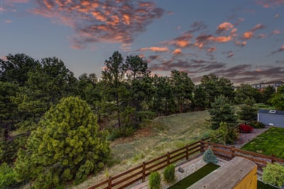 Expansive views of lush greenery and vibrant sunsets create a peaceful retreat in your backyard.