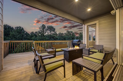 Relax on the spacious deck featuring a fire pit, surrounded by scenic views and vibrant sunsets.
