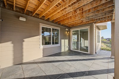 Spacious covered patio area perfect for outdoor entertaining and relaxing, featuring ample natural light.