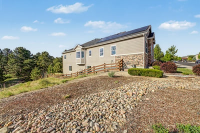 This spacious home features modern aesthetics, sustainable energy solutions, and stunning hillside views.