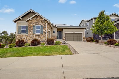 Modern home featuring a stone exterior, landscaped yard, and convenient garage in a welcoming neighborhood.