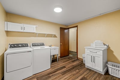 Large Laundry Room With Folding Area and Laundry Sink
