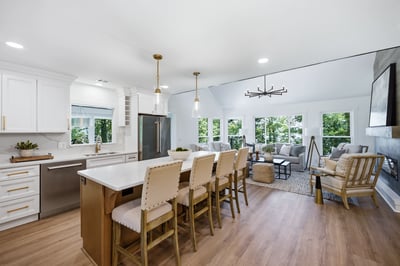 Bright and airy open-concept kitchen seamlessly connects to a spacious living area with abundant natural light.