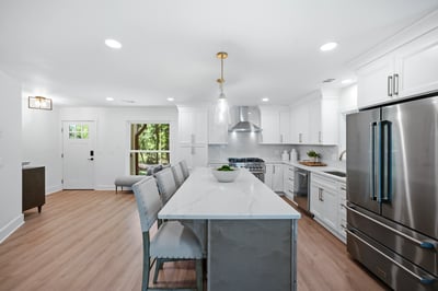 This modern kitchen features sleek cabinetry, a large island, and abundant natural light for an inviting atmosphere.