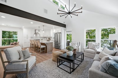 Modern open-concept living area featuring abundant natural light, contemporary fixtures, and a seamless flow to the kitchen.