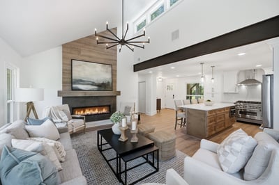 Bright and inviting living space featuring a modern kitchen, cozy fireplace, and ample natural light.