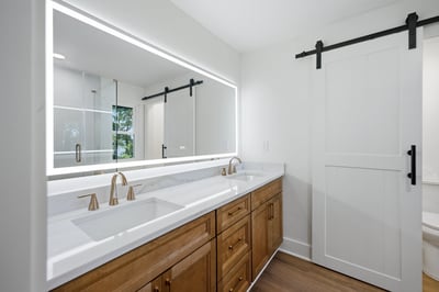 Bright and modern bathroom featuring dual sinks, sleek fixtures, and ample storage space for convenience.