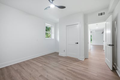 Bright, spacious bedroom featuring modern finishes and ample natural light, perfect for relaxed living.