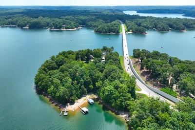Scenic waterfront property with expansive views, direct access to water, and nearby road connectivity for convenience.