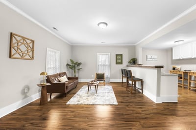 Spacious living area features hardwood floors and an open layout, perfect for entertaining and relaxation.
