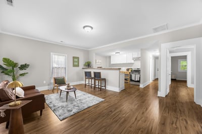 Bright, open-concept living space featuring modern finishes, hardwood floors, and a welcoming kitchen island.