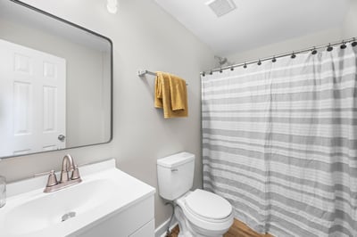 Modern bathroom featuring a clean design, updated fixtures, and ample natural light for a refreshing experience.