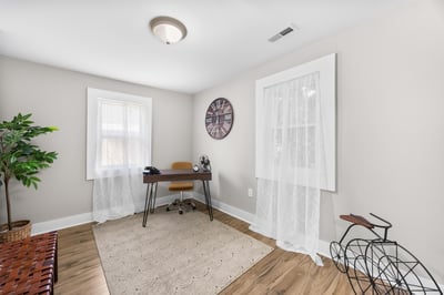 Bright home office featuring ample natural light and modern decor, perfect for remote work or study.
