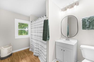 Bright and airy bathroom featuring a modern vanity and large window for natural light.