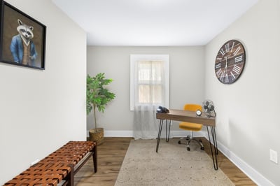 Bright and inviting workspace featuring modern decor, large window, and ample natural light.