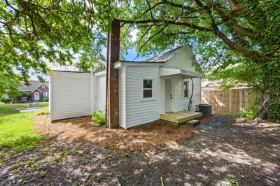Cozy home with a spacious backyard, offering potential for garden or outdoor entertainment.