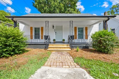 Discover this inviting home featuring a spacious porch, well-maintained landscaping, and a welcoming entrance.