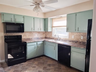 Apartment Kitchen when vacant but prior to cabinets painted & new counter Oct 2025 & prior to new range & microwave Dec 2025