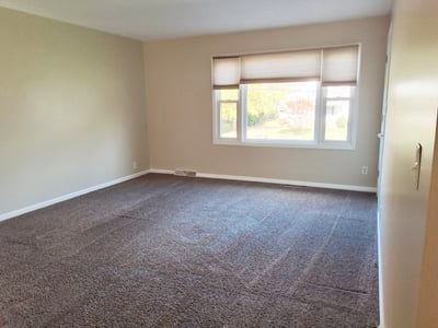 Apartment Living Room w/ storage closet, cordless shades & new carpet 2021 - empty view Fall 2025 before tenants