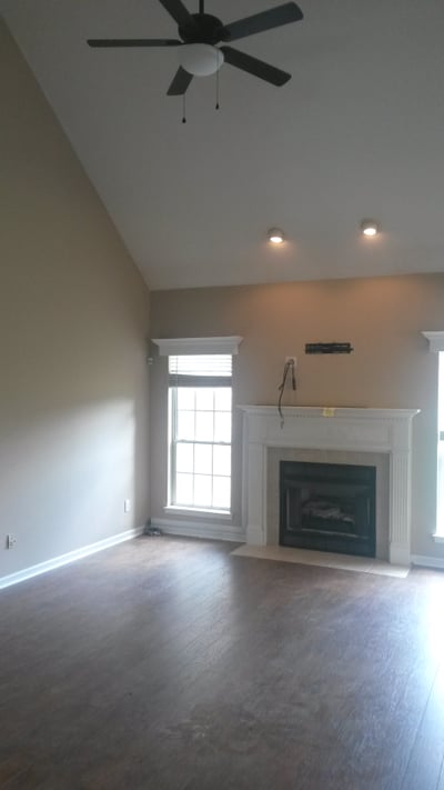 Bright living area featuring a fireplace and large windows, perfect for natural light and relaxation.