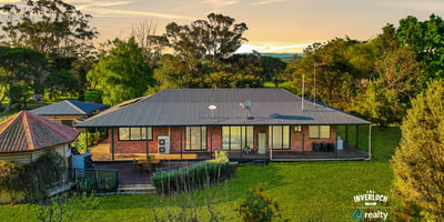 Spacious home set on lush grounds, featuring expansive outdoor areas and stunning views of the landscape.