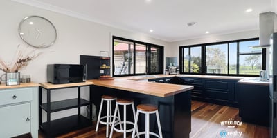 Bright and functional kitchen featuring modern appliances, ample counter space, and scenic views through expansive windows.