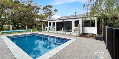 This spacious property features a large pool and versatile outdoor space, ideal for entertaining and relaxation.