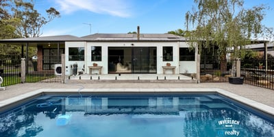 Contemporary home featuring a spacious poolside area, ideal for outdoor entertaining and relaxation.