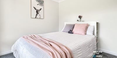 Bright and inviting bedroom featuring modern decor, soft textiles, and a peaceful atmosphere for relaxation.