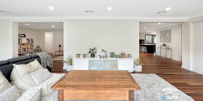 Spacious living area with modern design, featuring abundant light and seamless flow to adjacent rooms.