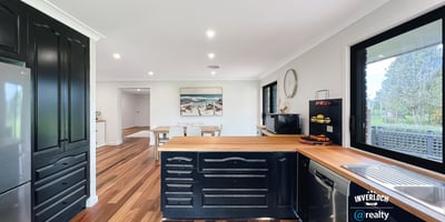 Modern kitchen featuring rich wood accents, ample counter space, and an open layout perfect for entertaining.