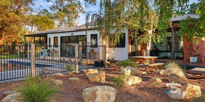 This inviting home features a spacious outdoor area with landscaped gardens and a relaxing poolside retreat.