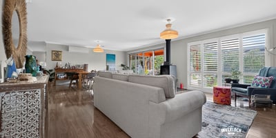Spacious open-concept living area with abundant natural light, featuring modern decor and inviting spaces for gatherings.