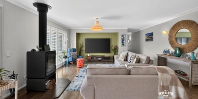 Bright and spacious living area featuring a modern fireplace and large windows for natural light.