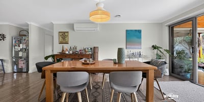 Bright and inviting dining area with modern furnishings, seamlessly connecting to an outdoor entertaining space.