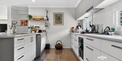 Modern kitchen featuring ample storage, sleek cabinetry, and a vibrant pop of color on the floor.