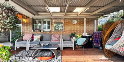 Inviting outdoor space featuring comfortable seating, vibrant decor, and a cozy atmosphere for relaxation and entertainment.