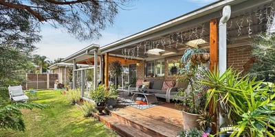 Spacious outdoor living area surrounded by lush landscaping, perfect for relaxation and entertaining.