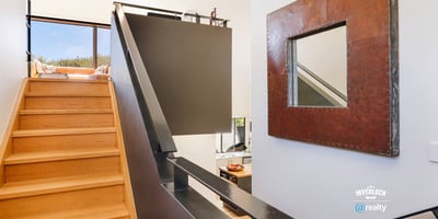 Modern staircase leads to an airy retreat with expansive views and contemporary design details.