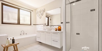 Bright and spacious bathroom featuring a soaking tub, modern shower, and ample storage for comfort and convenience.