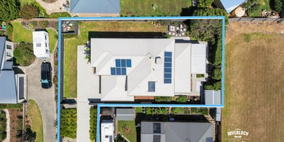 Spacious property featuring modern architecture, ample yard space, and energy-efficient solar panels, perfect for families.