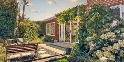 Discover this inviting outdoor space, featuring lush landscaping and a cozy seating area for relaxation.