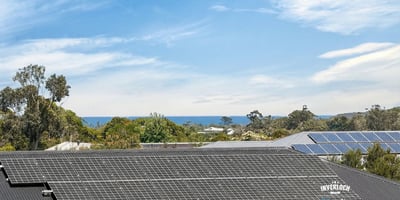 Modern home with solar panels and stunning ocean views, offering energy efficiency and coastal living.
