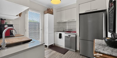 Modern kitchen featuring sleek appliances, ample storage, and natural light, perfect for culinary enthusiasts.