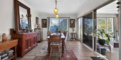 Spacious dining area featuring natural light, attractive décor, and easy access to a vibrant outdoor space.
