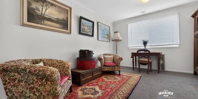 Bright and inviting living area featuring vintage decor, warm textiles, and ample natural light.