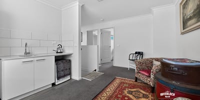 Spacious living area with kitchenette and versatile layout, perfect for personalized interior design and cozy gatherings.