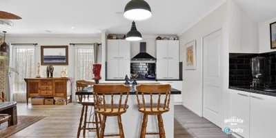 Modern kitchen with ample storage, featuring a central island and inviting dining area for casual meals.