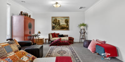 Spacious living area featuring diverse seating options and artwork, perfect for relaxation and gatherings.