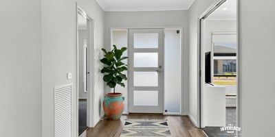 Bright entryway featuring contemporary design elements and welcoming greenery, perfect for creating lasting first impressions.